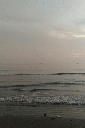 Dusk at a Lhokseumawe beach, with a soccer match on the side