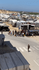 Water distribution crowds fill Khan Yunis camp streets