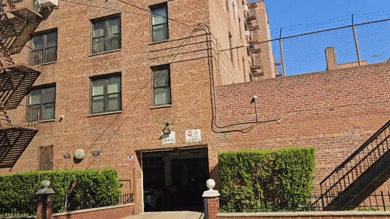 Brick apartment building with fire escape documented in New York