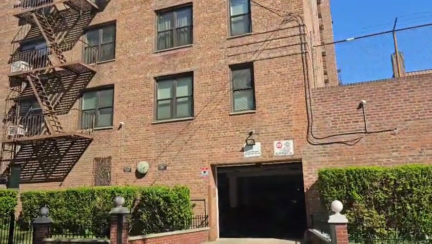 Brick apartment building with fire escape documented in New York
