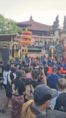 Traditional Balinese cultural performances and processions at Denpasar temple