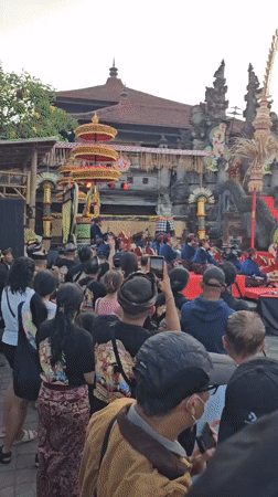 Traditional Balinese cultural performances and processions at Denpasar temple