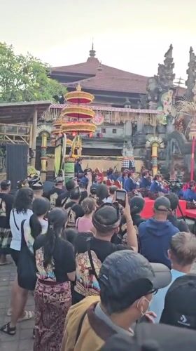 Traditional Balinese cultural performances and processions at Denpasar temple