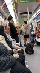 Street musician performs acoustic guitar on Buenos Aires subway