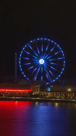 Lusail's illuminated Ferris wheel and waterfront captured in evening observations
