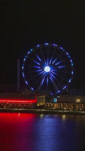 Lusail's illuminated Ferris wheel and waterfront captured in evening observations
