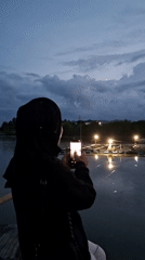 Evening smartphone photography session at Lhokseumawe waterfront dock
