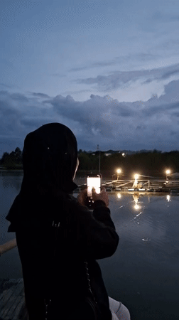 Evening smartphone photography session at Lhokseumawe waterfront dock