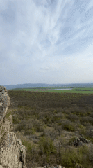 Hikers document scenic cliff views and forest trails