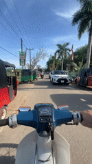 Motorcyclist travels through Sri Lankan towns during Buddhist festival celebration