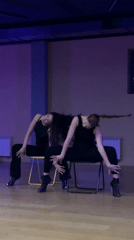 Dance duo rehearses synchronized chair routine in Balashikha studio