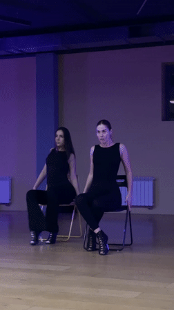 Dance duo rehearses synchronized chair routine in Balashikha studio
