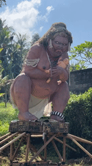 Large female statue with exaggerated features filmed in Gianyar