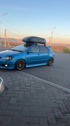 Two cars parked on roadside in Chernogorsk, Russia