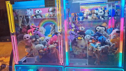 Neon-lit Ferris wheel and claw machines at a Pomorie fairground