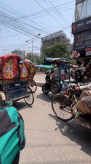 Morning street commerce bustles in Dhaka with rickshaws, vendors