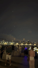 July 4th fireworks over a New York waterfront crowd