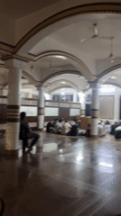 Inside a mosque with arched ceilings and decorative trim