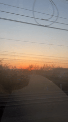 Passenger captures colorful sunset from moving train in Mechelen