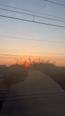 Passenger captures colorful sunset from moving train in Mechelen