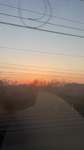 Passenger captures colorful sunset from moving train in Mechelen