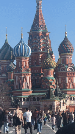 Tourists document Red Square landmarks under clear Moscow skies