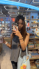 Woman takes mirror selfies in Liangjiang retail store
