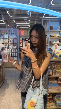 Woman takes mirror selfies in Liangjiang retail store