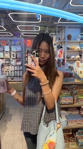 Woman takes mirror selfies in Liangjiang retail store