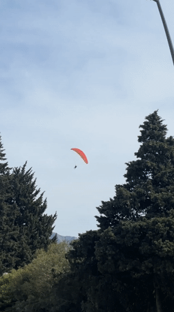 Red paraglider spotted flying over Budva, Montenegro