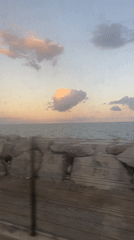 Passenger films calm ocean view from moving vehicle near Mataró