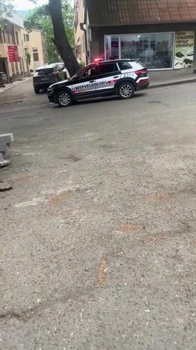 Police car with flashing lights parked in Gladzor, Armenia