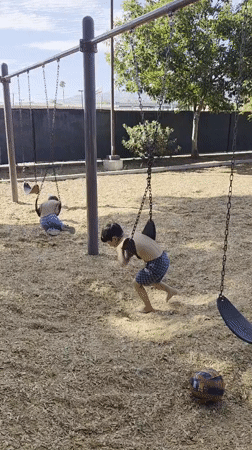 Kids playing at a Glendale playground on a summer evening