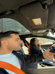 Couple films selfies during sunny car ride in Krasnoyarsk