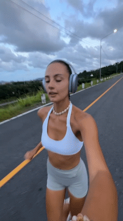 Woman films herself jogging on road in Chalong, Thailand