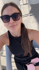 Woman sits outdoors in sunny Budva, Montenegro