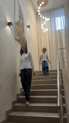 Woman and child descend stairs in Krasnoyarsk residence