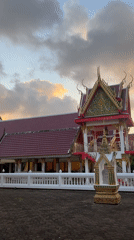 Choeng Thale temple at golden hour, monk passing by