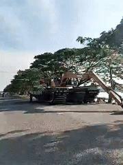 Floating excavator operates on Indonesian waterway near Lhokseumawe