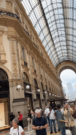 Busy morning crowds documented at Milan's historic Duomo and Galleria