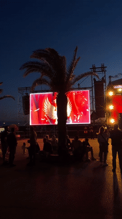 Evening outdoor event displays Montenegro flag in Bar