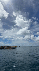 Boats on the water at Haad Yao's rocky coastline