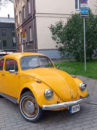 Yellow VW Beetle parked on Tallinn's cobblestone streets