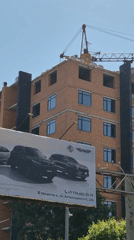 Construction crane active in Kokshetau commercial district