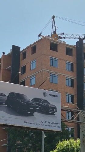 Construction crane active in Kokshetau commercial district