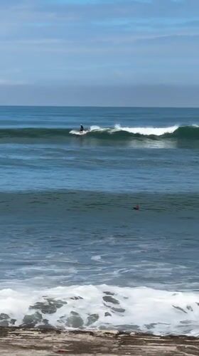Early morning surfing session captured off Kediri coast