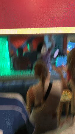 Bar celebration with green shots and announcements in São Paulo