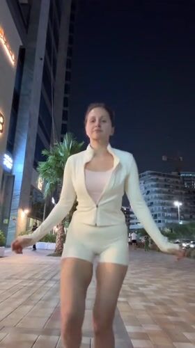 Woman exercises with jump rope at night in Dubai