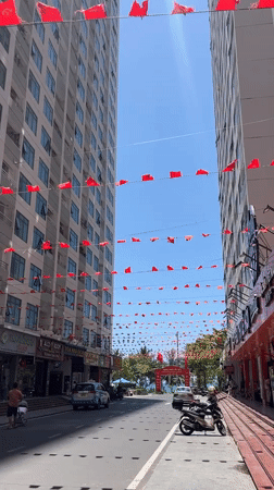 Red flags displayed across street in Nha Trang Ward