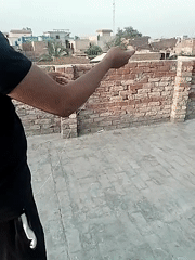 Children fly kites on rooftops in Dera Chahal, Pakistan